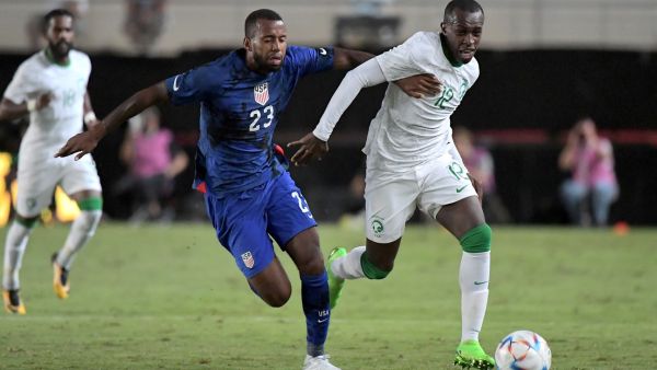 US midfielder Kellyn Acosta (L) vies with Saudi Arabia's defender Saud Abdulhamid during the friendly football match between Saudi Arabia and United States at the Nueva Condomina stadium in Murcia on September 27, 2022. (Photo by Jose Jordan / AFP)