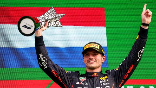 Red Bull Racing's Dutch driver Max Verstappen holds the winner's trophy on the podium of the Dutch Formula One Grand Prix at the Zandvoort circuit on September 4, 2022. (Photo by Kenzo TRIBOUILLARD / AFP)