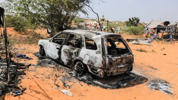 The remains of a police car following an explosion provocked by Al-Shabaab militants' during an attacke to a police station on the outskirts of Mogadishu, Somalia, on February 16, 2022. (Photo by Hassan Ali Elmi / AFP) Al-Shabaab