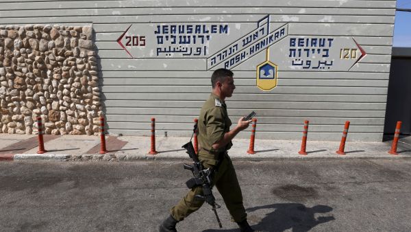 An Israeli soldier walks at the Rosh Hanikra border crossing between Lebanon and Israel, on October 7, 2022. (Photo by JALAA MAREY / AFP) gas deal