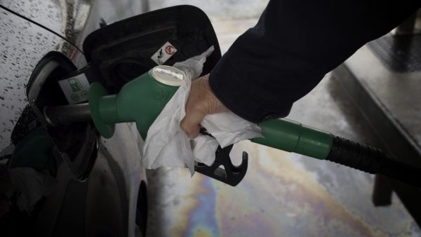 A motorist takes fuel at a gas station in Blois on October 14, 2022, as filling stations across France are low on petrol as a pay-related strike by workers at energy giant TotalEnergies entered its third week despite government pressure to negotiate.(Photo by GUILLAUME SOUVANT / AFP) fuel shortages