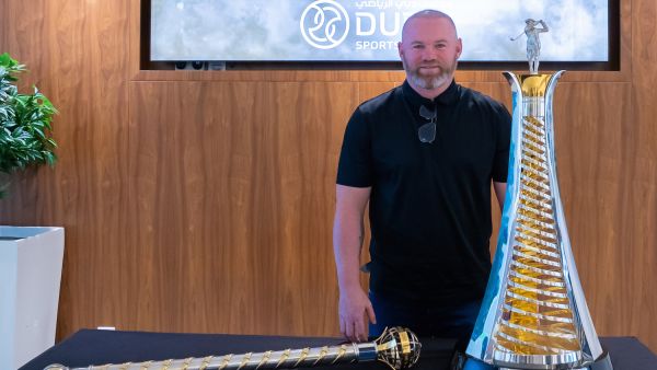 Wayne Rooney poses with the Harry Vardon Trophy and the DP World Tour Championship trophy at the Dubai Sports Council offices (Image credit: Supplied)