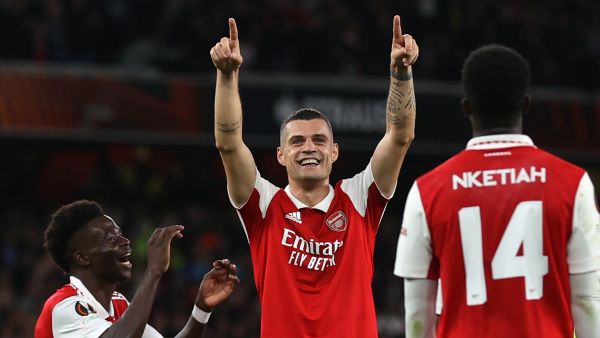Arsenal's Swiss midfielder Granit Xhaka (C) celebrates with teammates after scoring the opening goal of the UEFA Europa League Group A football match between Arsenal and PSV Eindhoven at The Arsenal Stadium in London, on October 20, 2022. (Photo by ADRIAN DENNIS / AFP)