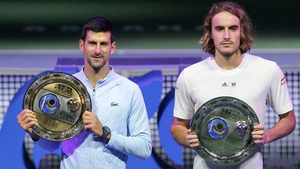 Serbia's Novak Djokovic (L) poses with his trophy after defeating Greece's Stefanos Tsitsipas (R) in their men's singles final match at the Astana Open tennis tournament in Astana on October 9, 2022. (Photo by AFP)