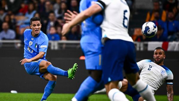 Italy's midfielder Giacomo Raspadori (L) scores a goal during the UEFA Nations League's League A Group 3 match between Italy and England, at the San Siro Stadium in Milan on September 23, 2022. (Photo by Marco BERTORELLO / AFP)