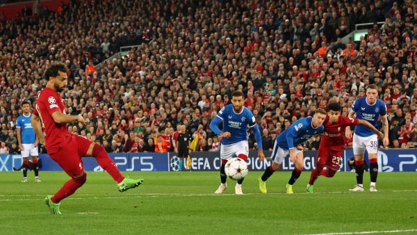 Liverpool's Egyptian striker Mohamed Salah (L) shoots from the penalty spot to score their second goal during UEFA Champions League group A football match between Liverpool and Glasgow Rangers at Anfield in Liverpool, north west England on October 4, 2022. (Photo by Nigel Roddis / AFP)