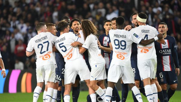 Marseille's French defender Samuel Gigot (2R) receives a red card after tackling Paris Saint-Germain's Brazilian forward Neymar (down) during the French L1 football match between Paris Saint-Germain (PSG) and Olympique de Marseille (OM) at the Parc des Princes Stadium in Paris, on October 16, 2022. (Photo by Bertrand GUAY / AFP)