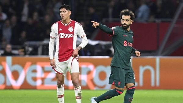 Liverpool's Egyptian striker Mohamed Salah (R) celebrates scoring his team's first goal as Ajax's Mexican defender Edson Alvarez (L) looks on during the UEFA Champions League group A football match between Ajax Amsterdam and Liverpool at the Johan Cruijff ArenA in Amsterdam, on October 26, 2022. (Photo by JOHN THYS / AFP)