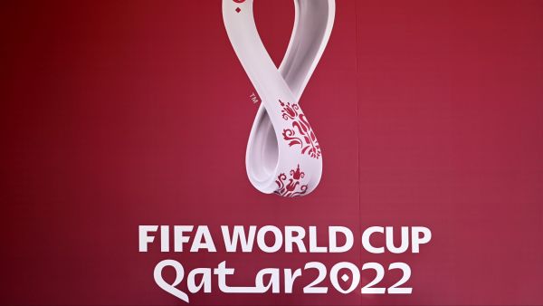The logo of the Qatar 2022 FIFA World Cup football tournament is displayed on a wall in Doha on October 23, 2022. (Photo by Gabriel BOUYS / AFP)