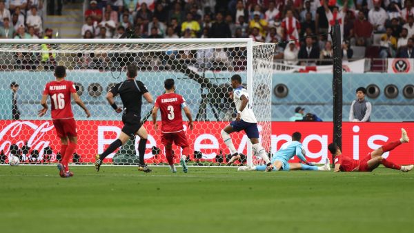 England's forward #11 Marcus Rashford (C) scores his team's fifth goal during the Qatar 2022 World Cup Group B football match between England and Iran at the Khalifa International Stadium in Doha on November 21, 2022. (Photo by Adrian DENNIS / AFP)