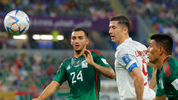 Mexico's midfielder #24 Luis Chavez (L) fights for the ball with Poland's forward #09 Robert Lewandowski during the Qatar 2022 World Cup Group C football match between Mexico and Poland at Stadium 974 in Doha on November 22, 2022. (Photo by Odd ANDERSEN / AFP)