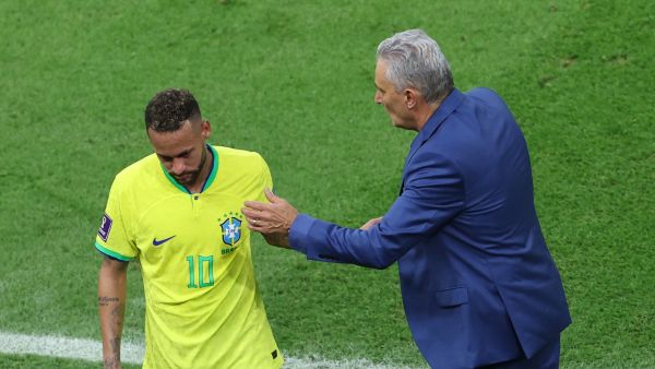Brazil's coach #00 Tite greets Brazil's forward #10 Neymar as he is replaced during the Qatar 2022 World Cup Group G football match between Brazil and Serbia at the Lusail Stadium in Lusail, north of Doha on November 24, 2022. (Photo by Giuseppe CACACE / AFP)