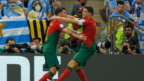 Portugal's forward #07 Cristiano Ronaldo (R) celebrates with Portugal's midfielder #08 Bruno Fernandes after he scored his team's first goal during the Qatar 2022 World Cup Group H football match between Portugal and Uruguay at the Lusail Stadium in Lusail, north of Doha on November 28, 2022. (Photo by Odd ANDERSEN / AFP)