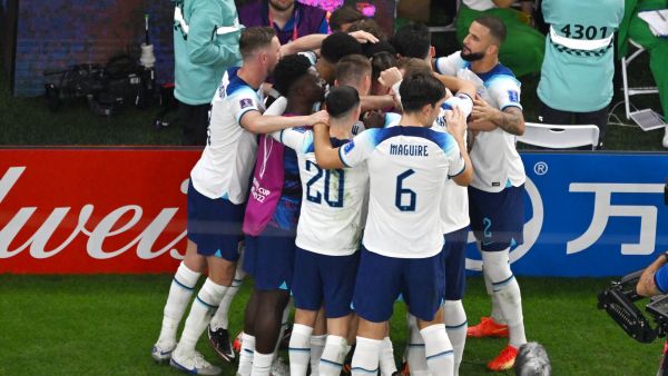 England's players celebrate after England's forward #11 Marcus Rashford scored their team's first goal during the Qatar 2022 World Cup Group B football match between Wales and England at the Ahmad Bin Ali Stadium in Al-Rayyan, west of Doha on November 29, 2022. (Photo by Antonin THUILLIER / AFP)