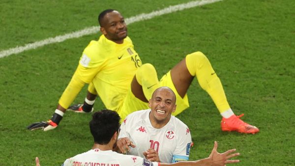 Tunisia's forward #10 Wahbi Khazri (C) celebrates with Tunisia's midfielder #15 Mohamed Ali Ben Romdhane after scoring his team's first goal past France's goalkeeper #16 Steve Mandanda during the Qatar 2022 World Cup Group D football match between Tunisia and France at the Education City Stadium in Al-Rayyan, west of Doha on November 30, 2022. (Photo by Adrian DENNIS / AFP)