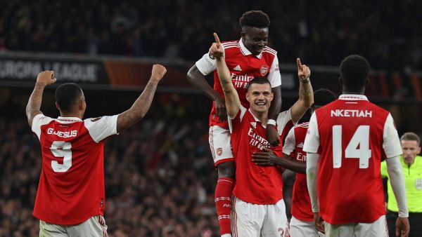 Arsenal's Swiss midfielder Granit Xhaka (C) celebrates with teammates after scoring the opening goal of the UEFA Europa League Group A football match between Arsenal and PSV Eindhoven at The Arsenal Stadium in London, on October 20, 2022. (Photo by ADRIAN DENNIS / AFP)