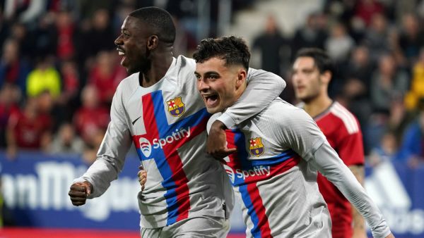 Barcelona's Spanish midfielder Pedri (R) celebrates with Barcelona's French forward Ousmane Dembele after scoring his team's first goal during the Spanish league football match between CA Osasuna and FC Barcelona at El Sadar stadium in Pamplona on November 8, 2022. (Photo by CESAR MANSO / AFP)