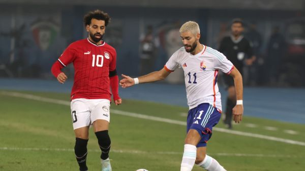 Egypt's forward Mohamed Salah (L) and Belgium's midfielder Yannick Carrasco vie for the ball during the friendly football match between Belgium and Egypt at the Jaber Al-Ahmad Stadium in Kuwait City on November 18, 2022. (Photo by Yasser Al-Zayyat / AFP)
