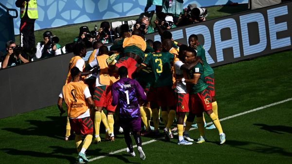 Cameroon's players celebrate after scoring a goal during the Qatar 2022 World Cup Group G football match between Cameroon and Serbia at the Al-Janoub Stadium in Al-Wakrah, south of Doha on November 28, 2022. (Photo by Anne-Christine POUJOULAT / AFP)