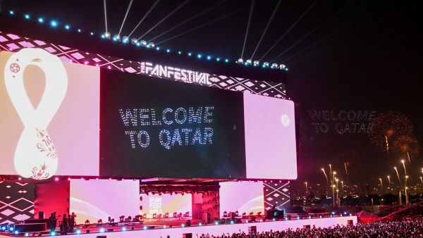 Supporters watch fireworks on a giant screen during the FIFA Fan Festival opening day at Al Bidda park in Doha on November 19, 2022, ahead of the Qatar 2022 World Cup football tournament. (Photo by Kirill KUDRYAVTSEV / AFP)