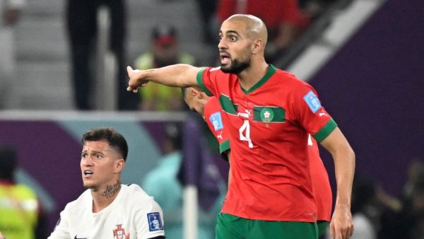 Portugal's midfielder #25 Otavio (L) and Morocco's midfielder #04 Sofyan Amrabat (R) react during the Qatar 2022 World Cup quarter-final football match between Morocco and Portugal at the Al-Thumama Stadium in Doha on December 10, 2022. (Photo by PATRICIA DE MELO MOREIRA / AFP)