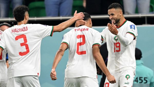 Morocco's forward #19 Youssef En-Nesyri (R) celebrates with Morocco's defender #02 Achraf Hakimi (C) and Morocco's defender #03 Noussair Mazraoui after he scored his team's first goal during the Qatar 2022 World Cup Group F football match between Canada and Morocco at the Al-Thumama Stadium in Doha on December 1, 2022. (Photo by NATALIA KOLESNIKOVA / AFP)
