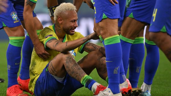 Brazil's forward #10 Neymar is consoled by teammates after they lost the Qatar 2022 World Cup quarter-final football match between Croatia and Brazil at Education City Stadium in Al-Rayyan, west of Doha, on December 9, 2022. (Photo by NELSON ALMEIDA / AFP)