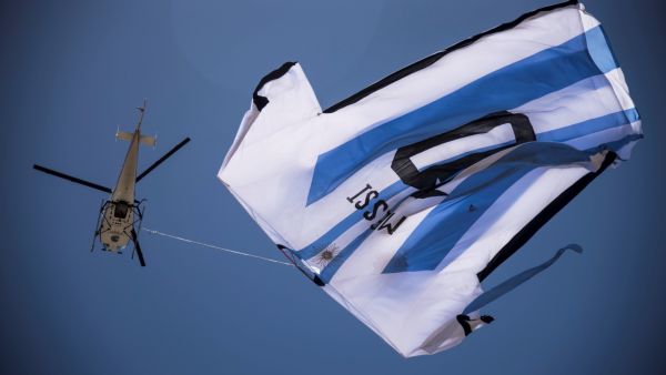 A helicopter carries a giant t-shirt of Argentina forward Lionel Messi over Rosario, Argentina, on December 13, 2022, before the Qatar 2022 World Cup semi-final football match between Argentina and Croatia. (Photo by AFP) Lionel Messi
