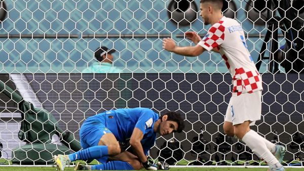 Croatia's forward #09 Andrej Kramaric (R) celebrates as Morocco's goalkeeper #01 Yassine Bounou fails to save their second goal during the Qatar 2022 World Cup third place play-off football match between Croatia and Morocco at Khalifa International Stadium in Doha on December 17, 2022. (Photo by JACK GUEZ / AFP)