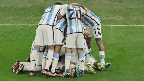 Argentina's midfielder #11 Angel Di Maria (C) celebrates with teammates after scoring his team's second goal during the Qatar 2022 World Cup final football match between Argentina and France at Lusail Stadium in Lusail, north of Doha on December 18, 2022. (Photo by JACK GUEZ / AFP)