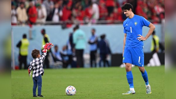 Morocco's goalkeeper #01 Yassine Bounou plays with his son Isaac as he celebrates winning the Qatar 2022 World Cup quarter-final football match between Morocco and Portugal at the Al-Thumama Stadium in Doha on December 10, 2022. (Photo by Kirill KUDRYAVTSEV / AFP) Yassine Bounou