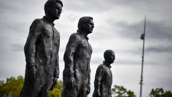 A picture of the installation "Anything to Say?", a bronze sculpture and art installation by Italian sculptor Davide Dormino representing whistleblowers (from L) Edward Snowden, Julian Assange and Chelsea Manning is seen on the Place des Nations next to the United Nations Offices in Geneva, on September 15, 2015. AFP PHOTO / FABRICE COFFRINI Elon Musk