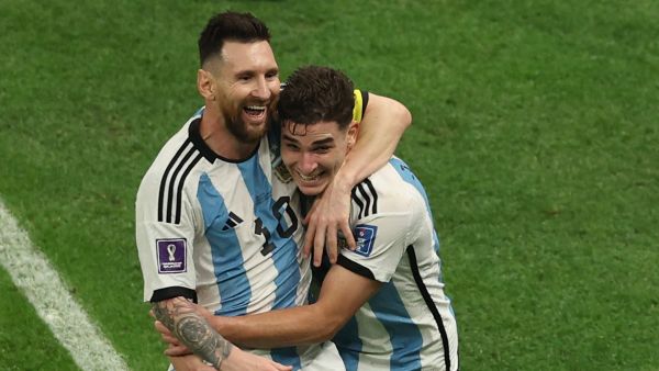 Argentina's forward #09 Julian Alvarez (R) celebrates with Argentina's forward #10 Lionel Messi after scoring his team's second goal during the Qatar 2022 World Cup football semi-final match between Argentina and Croatia at Lusail Stadium in Lusail, north of Doha on December 13, 2022. (Photo by Adrian DENNIS / AFP)