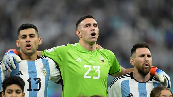 Argentina's defender #13 Cristian Romero, Argentina's goalkeeper #23 Emiliano Martinez and Argentina's forward #10 Lionel Messi sing the national anthem ahead of the Qatar 2022 World Cup football semi-final match between Argentina and Croatia at Lusail Stadium in Lusail, north of Doha on December 13, 2022. (Photo by JUAN MABROMATA / AFP)