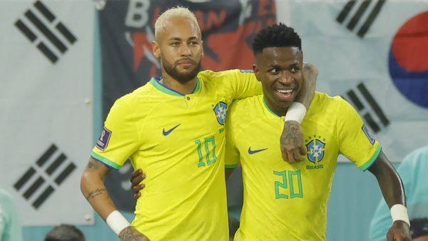 Brazil's forward #20 Vinicius Junior (R) celebrates scoring his team's first goal with Brazil's forward #10 Neymar during the Qatar 2022 World Cup round of 16 football match between Brazil and South Korea at Stadium 974 in Doha on December 5, 2022. (Photo by Odd ANDERSEN / AFP)
