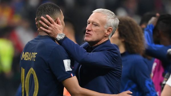France's coach Didier Deschamps embraces France's forward #10 Kylian Mbappe at the end of the Qatar 2022 World Cup semi-final football match between France and Morocco at the Al-Bayt Stadium in Al Khor, north of Doha on December 14, 2022. (Photo by FRANCK FIFE / AFP)