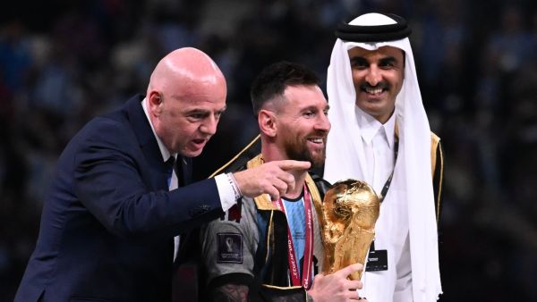 Argentina's captain and forward #10 Lionel Messi holds the FIFA World Cup Trophy next to FIFA President Gianni Infantino and Qatar's Emir Sheikh Tamim bin Hamad al-Thani (R) during the trophy ceremony after Argentina won the Qatar 2022 World Cup final football match between Argentina and France at Lusail Stadium in Lusail, north of Doha on December 18, 2022. (Photo by Kirill KUDRYAVTSEV / AFP)