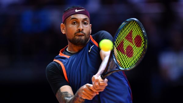 Australia's Nick Kyrgios plays the ball to Bulgaria's Grigor Dimitrov during their 2022 World Tennis League exhibition match at Dubai’s Coca-Cola arena in the United Arab Emirates, on December 21, 2022. (Photo by AFP)
