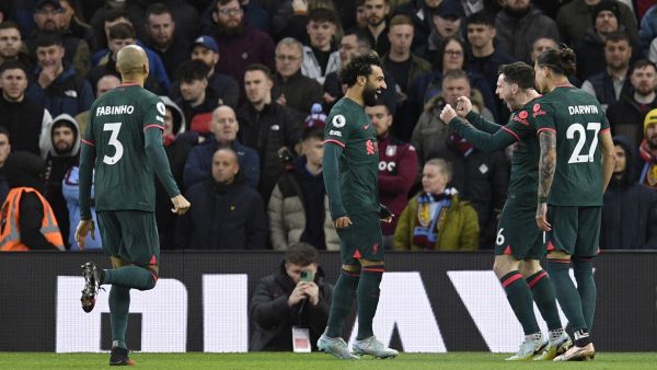 Liverpool's Egyptian striker Mohamed Salah celebrates with teammates after scoring his team first goal during the English Premier League football match between Aston Villa and Liverpool at Villa Park in Birmingham, central England on December 26, 2022. (Photo by Oli SCARFF / AFP) 