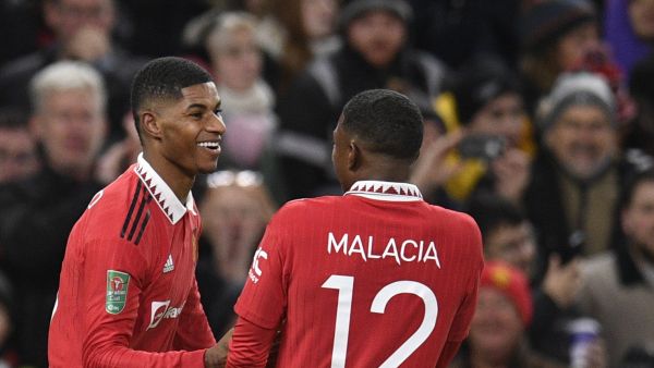 Manchester United's English striker Marcus Rashford (L) celebrates after scoring his team second goal during the English League Cup fourth round football match between Manchester United and Burnley, at Old Trafford, in Manchester, on December 21, 2022. (Photo by Oli SCARFF / AFP)