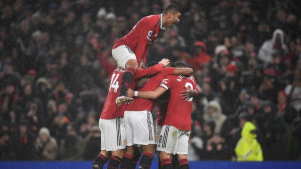 Manchester United's French striker Anthony Martial (C) celebrates with teammates after scoring his team second goal during the English Premier League football match between Manchester United and Nottingham Forest at Old Trafford in Manchester, north west England, on December 27, 2022. (Photo by Oli SCARFF / AFP)
