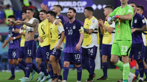 Argentina's forward #10 Lionel Messi (C) along with teammates walk off the pitch after winning the Qatar 2022 World Cup Group C football match between Poland and Argentina at Stadium 974 in Doha on November 30, 2022. (Photo by Giuseppe CACACE / AFP)