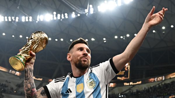 Argentina's captain and forward #10 Lionel Messi, his wife Antonela Roccuzzo and sons Thiago (C) and Ciro pose with the FIFA World Cup Trophy after Argentina won the Qatar 2022 World Cup final football match between Argentina and France at Lusail Stadium in Lusail, north of Doha on December 18, 2022. (Photo by Anne-Christine POUJOULAT / AFP)