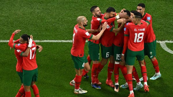Morocco's forward #19 Youssef En-Nesyri (C) celebrates scoring his team's first goal with teammates during the Qatar 2022 World Cup quarter-final football match between Morocco and Portugal at the Al-Thumama Stadium in Doha on December 10, 2022. (Photo by MANAN VATSYAYANA / AFP)