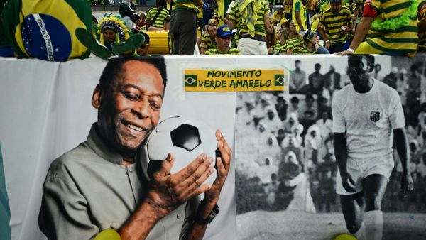 Brazil legend Pele is displayed on large banners near the crowd during the Qatar 2022 World Cup Group G football match between Cameroon and Brazil at the Lusail Stadium in Lusail, north of Doha on December 2, 2022. (Photo by Jewel SAMAD / AFP)