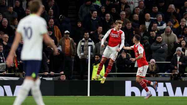 Arsenal's Norwegian midfielder Martin Odegaard (C) celebrates scoring the team's second goal during the English Premier League football match between Tottenham Hotspur and Arsenal at Tottenham Hotspur Stadium in London, on January 15, 2023. (Photo by ADRIAN DENNIS / AFP)