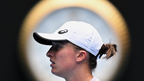 Poland's Iga Swiatek gets ready to serve against Kazakhstan's Elena Rybakina during their women's singles match on day seven of the Australian Open tennis tournament in Melbourne on January 22, 2023. (Photo by Manan VATSYAYANA / AFP)