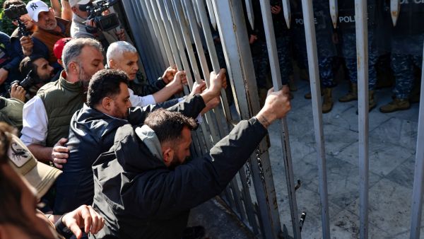 Relatives of victims of the 2020 Beirut port explosion, push against the entrance gate of the palace of justice in the Lebanese capital, during a rally to support the judge investigating the disaster, on Jan. 26. (Photo by Joseph EID / AFP) Beirut blast