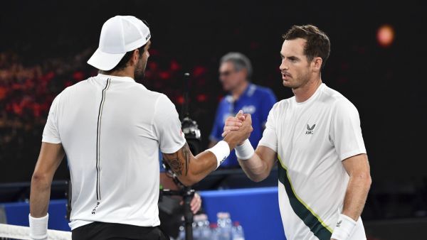 Britain's Andy Murray (R) shakes hands Italy's Matteo Berrettini after their men's singles match on day two of the Australian Open tennis tournament in Melbourne on January 17, 2023. (Photo by Paul CROCK / AFP)