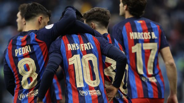 Barcelona's Spanish forward Ansu Fati is congratulated by teammates for scoring their second goal during the Spanish Super Cup semi-final football match between Real Betis and FC Barcelona at the King Fahd International Stadium in Riyadh, Saudi Arabia, on January 12, 2023. (Photo by Giuseppe CACACE / AFP)